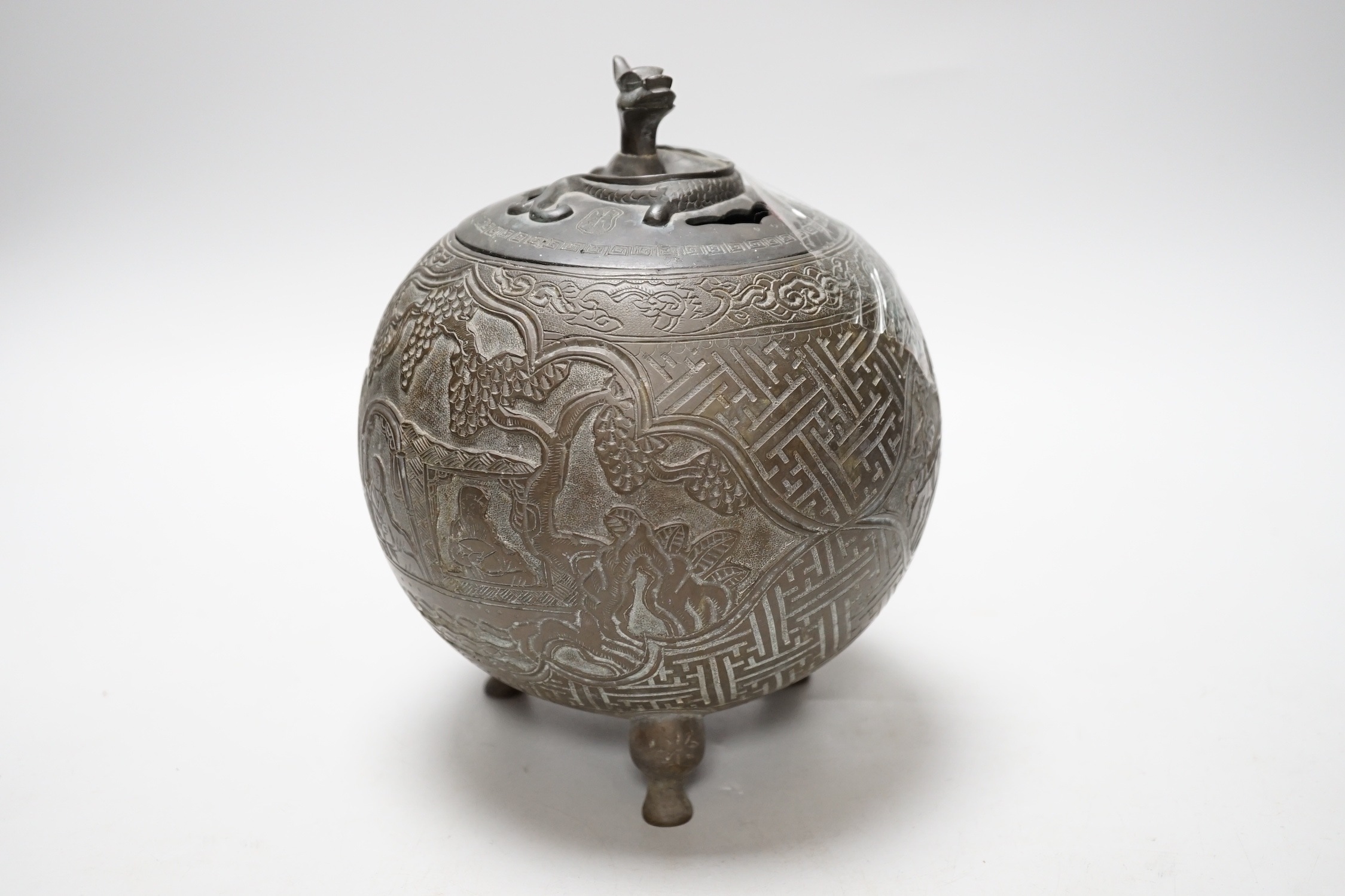 A Chinese three footed cast and chased bronze globular censer and cover, c.1900, 20cm high